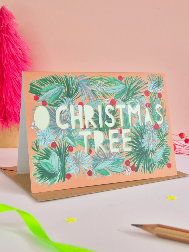 Holly berry and pine branch illustration card with O Christmas Tree paper cut text, backed with pearlescent green paper 