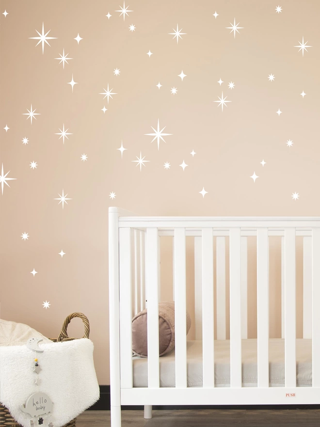 twinkly stars wall sticker set in white on a pink wall