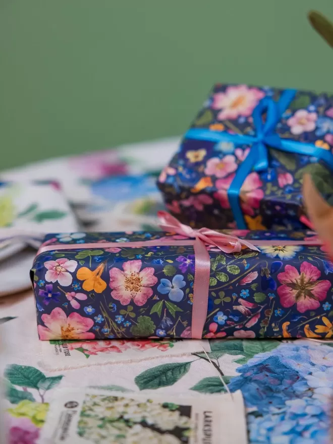 Present wrapped in pretty pressed flower luxury gift wrap paper