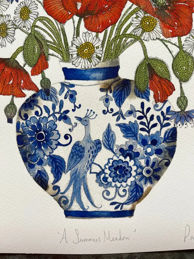 summer meadow flowers, red poppies, cornflowers and daisies in a delftware ceramic vase