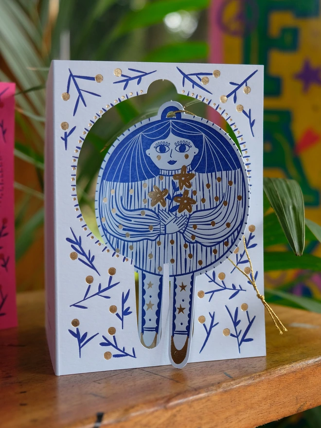 Christmas card with pop-out Bauble Lady. Hand printed in Blue ink with gold foil berries, flowers and spots. 