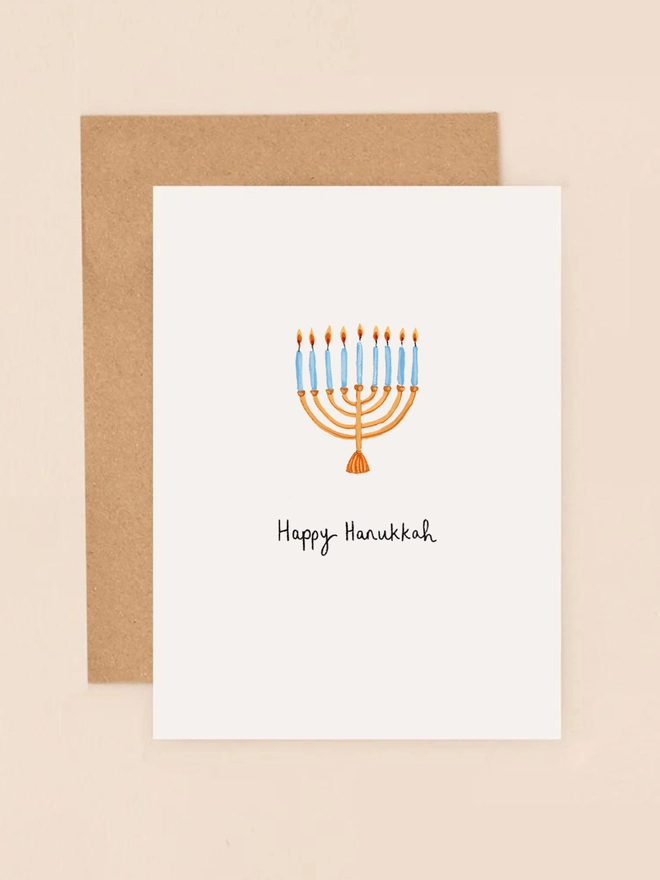 A festive illustration featuring a traditional menorah with nine candles, each glowing warmly. The design captures the essence of Hanukkah, radiating warmth and celebration. The card's compact size and elegant details make it a perfect choice for sending heartfelt holiday greetings.