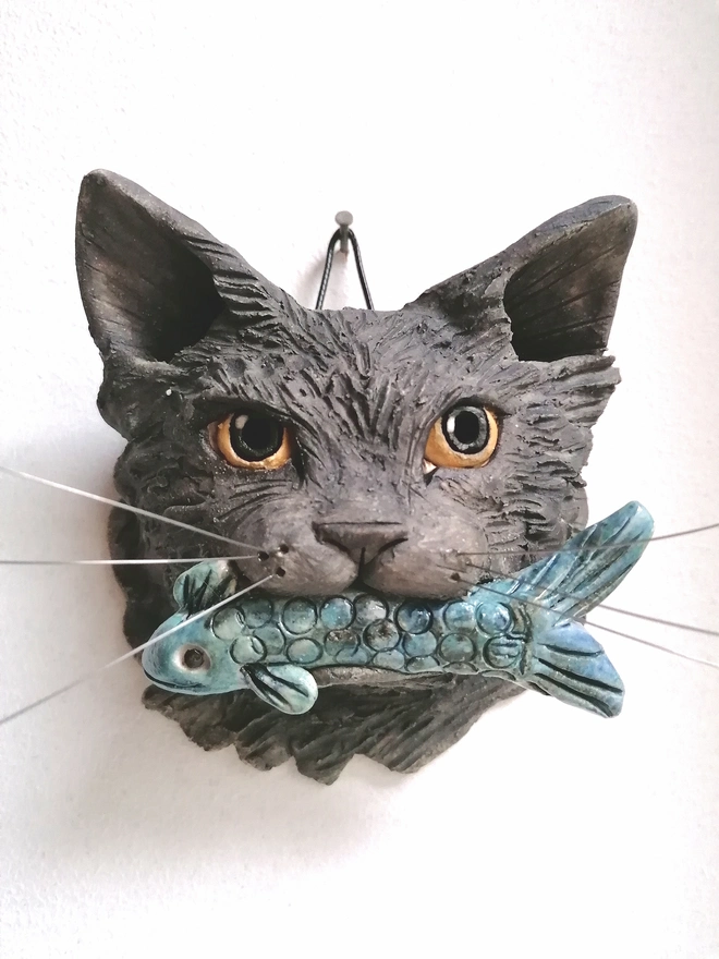 Grey fluffy cat with fish