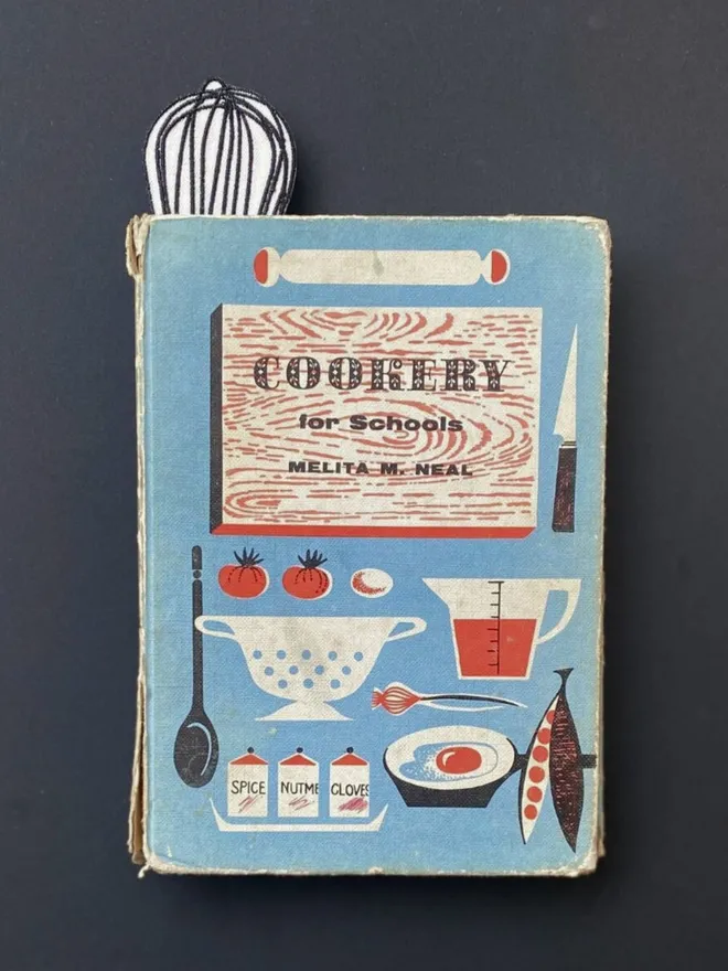 Whisk bookmark inside vintage cookbook