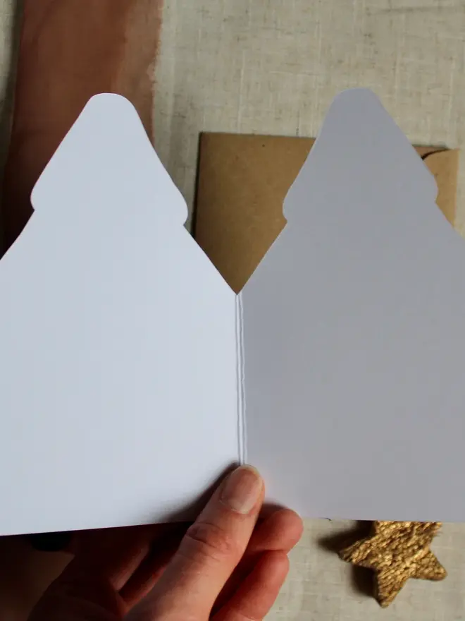 illustrated christmas tree card. christmas tree shaped card unfolded to show blank inside.