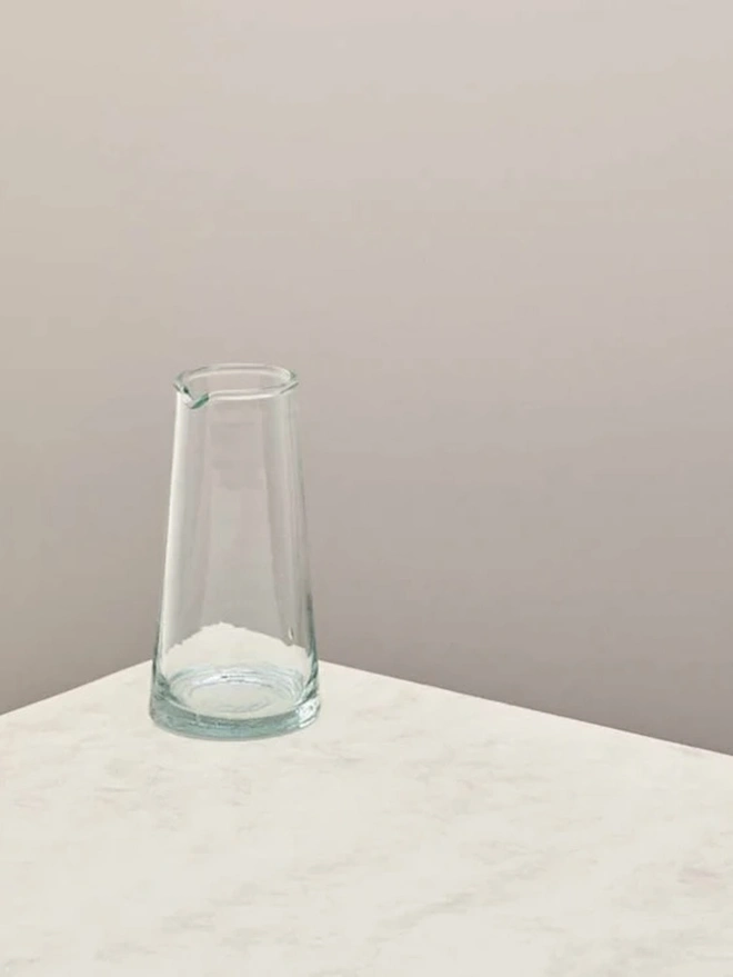 Whisky Glasses (Set Of 3), a jug sitting on a plain counter top against a grey backdrop. 