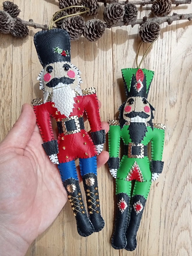 Hetty and Dave leatherette nutcracker decorations. One is green, the other red