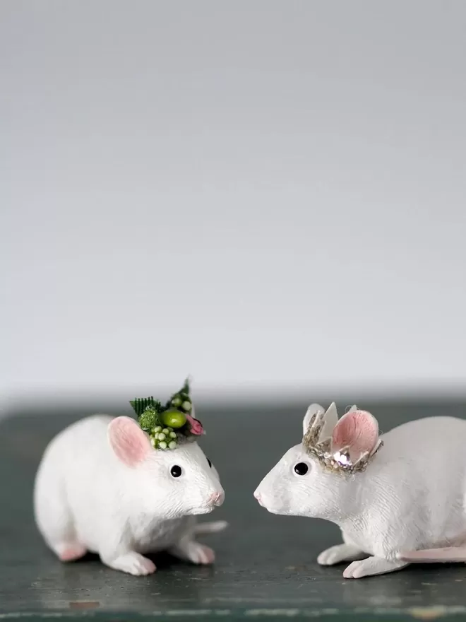 Two mice with hats.
