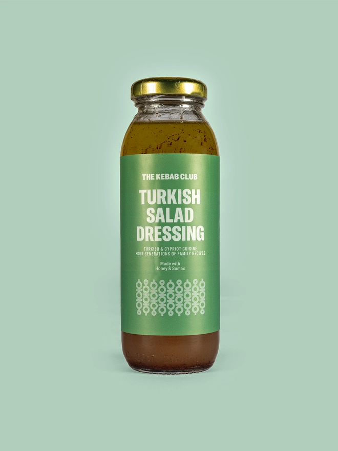 jar of turkish salad dressing on green background