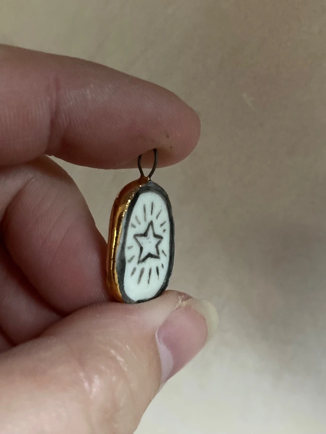 star pendant held for scale