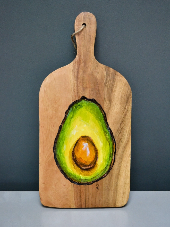 Wooden serving board with handpainted avocado design