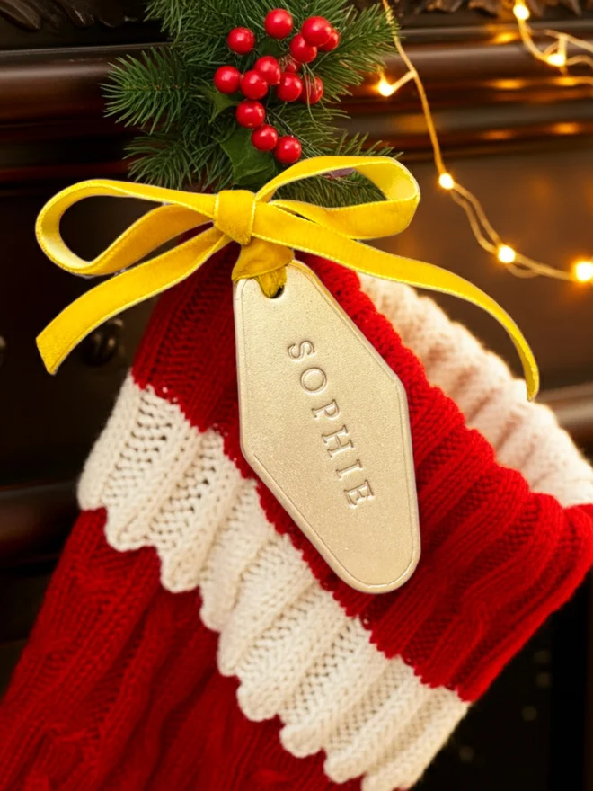 Gold Leather stocking label with the name Sophie written on it.