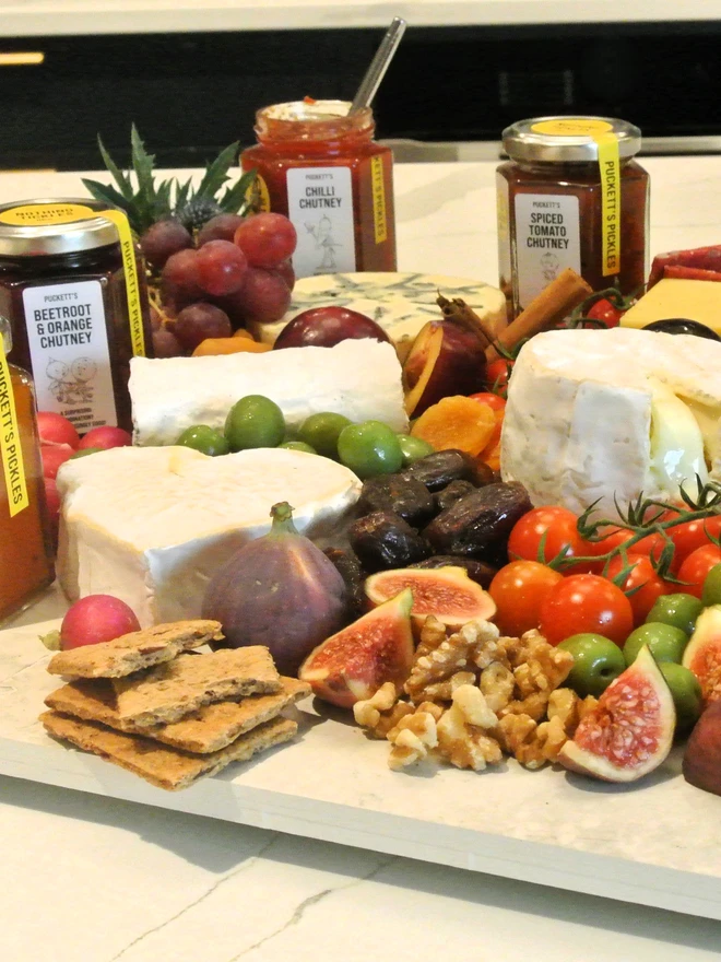 chill chutney. a charcuterie board featuring assorted jars of artisan chutney. 
