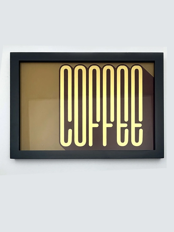 'Coffee' Gold Leaf Glass Artwork, hanging on a white background 