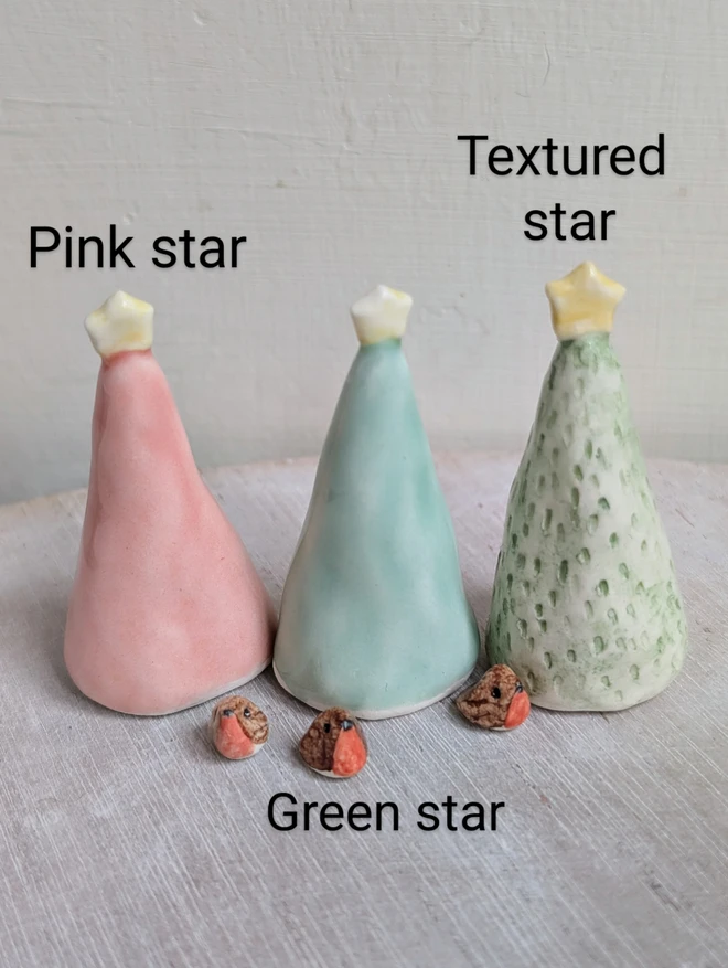 3 christmas trees and mini robins in ceramic the trees are green or pink