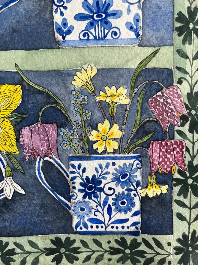 daffodils, snowdrops and spring flowers in delftware teacups displayed in a plant theatre