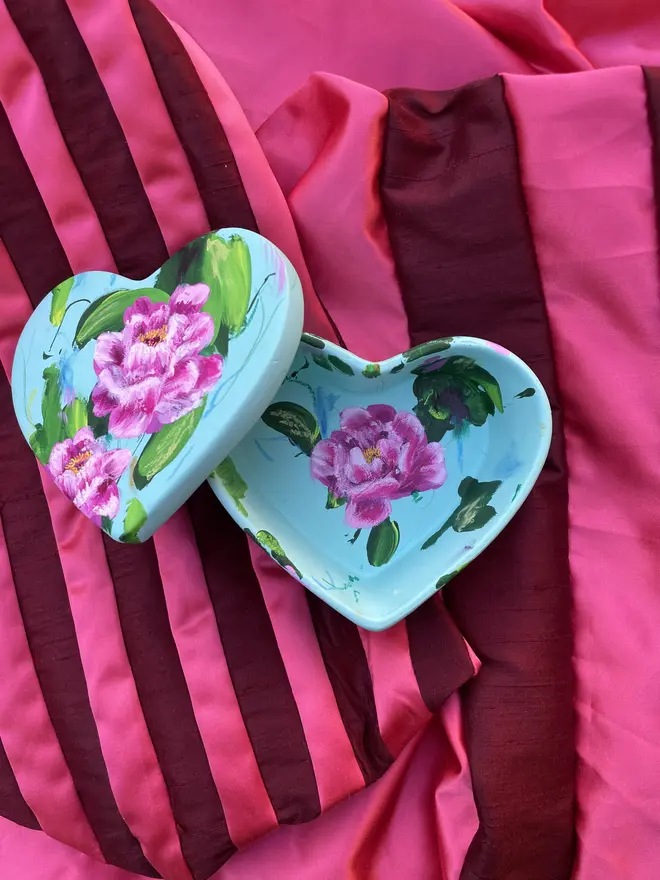 hand painted floral ceramic heart shaped keepsake box background in a light blue with pink and white peony flowers