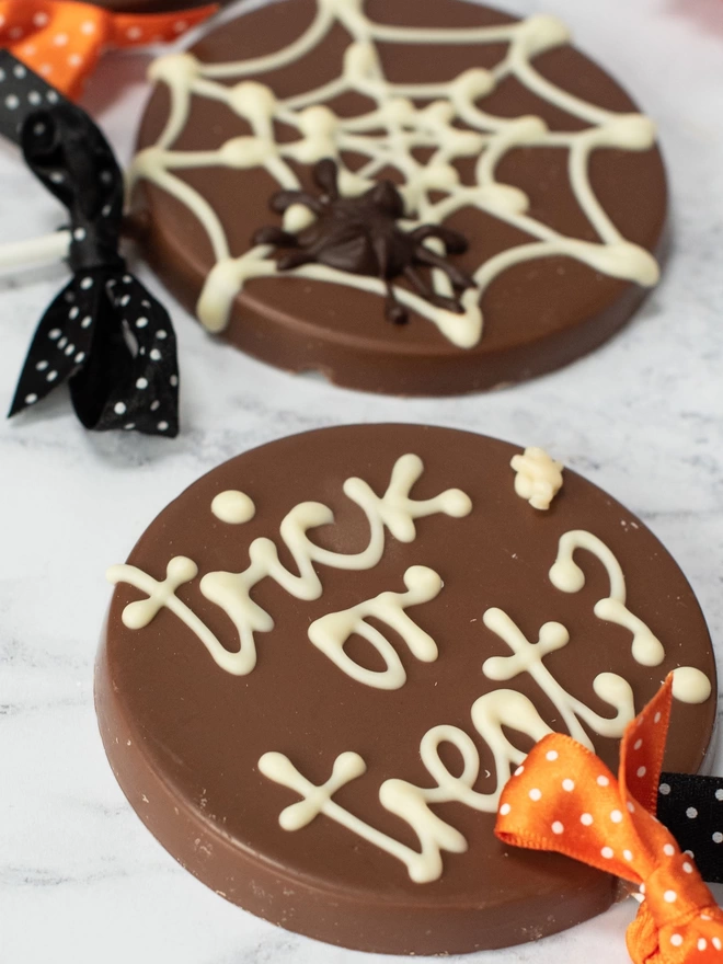 Spiderweb and trick or treat chocolate lollipops