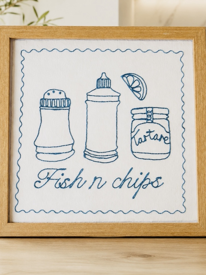 Framed 'Fish N Chips' Embroidered Wall Art, a fish and chips themed artwork in a wooden frame