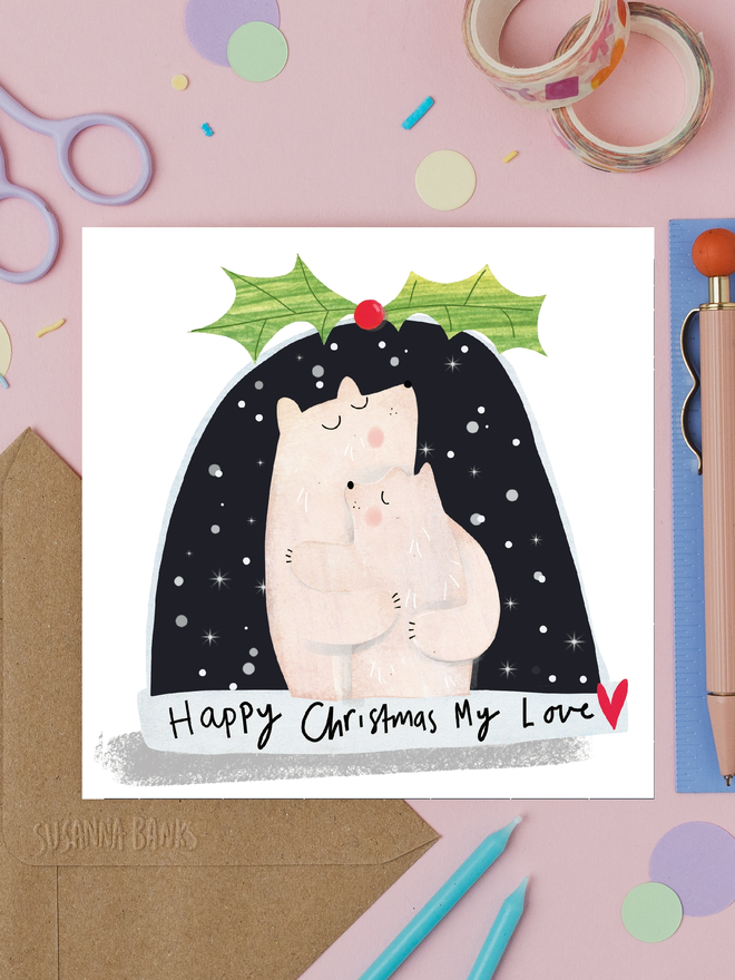 'my love' snow globe christmas card. card photographed on table with various craft items.