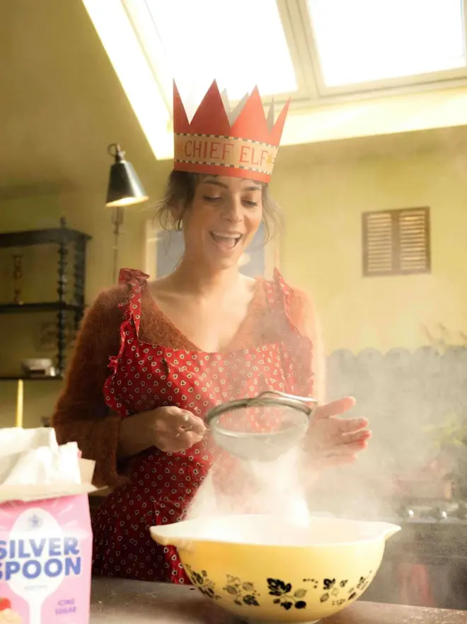 woman wearing red paper crown card with chief elf text