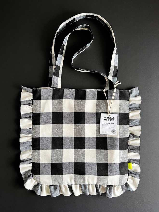 Black and white check cloth tote bag with ruffle edge detail
