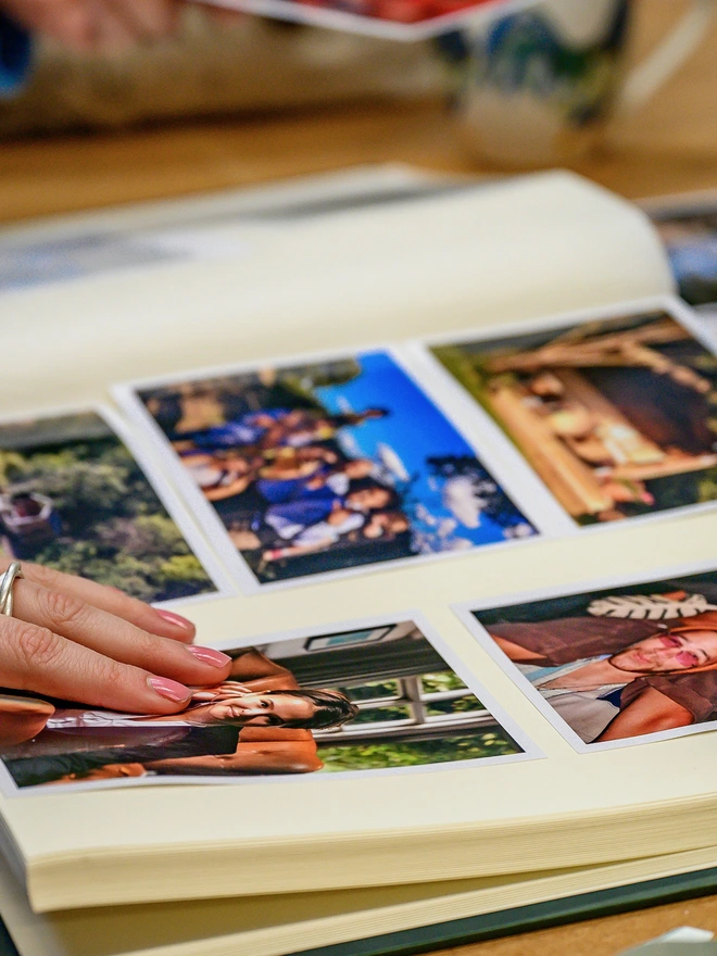 A Handmade & Personalised Anniversary Photo Album is lying open and is filled with photos of family and friends.