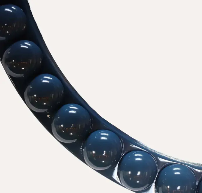 Round oversized bobbin mirror with a decorative bobbin-style wooden frame, hanging on a white wall.