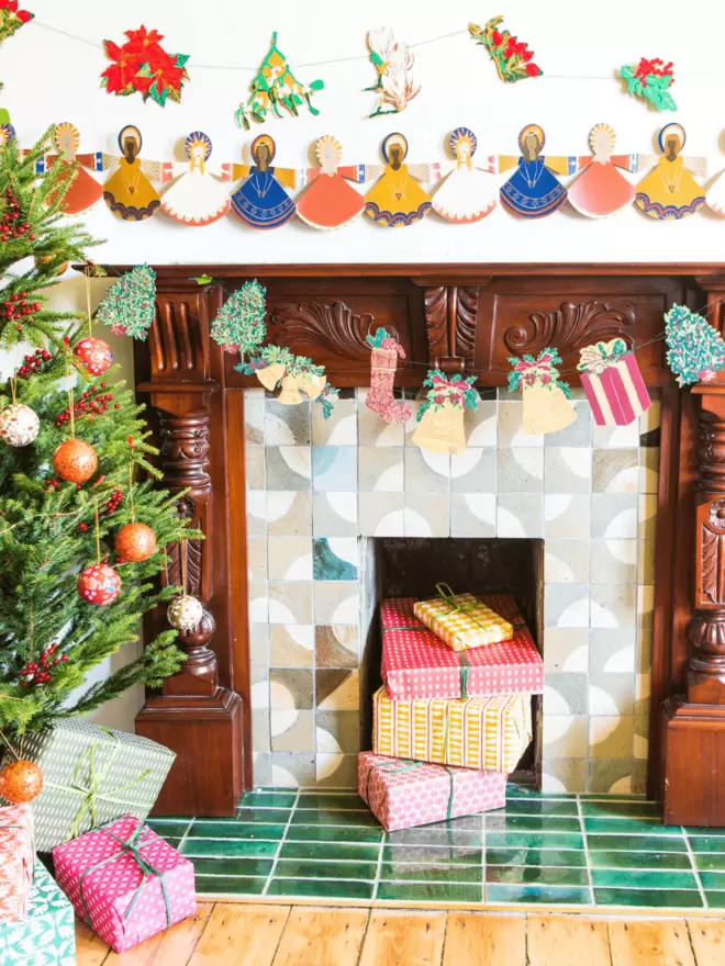 Christmas set up with garland hanging over fireplace