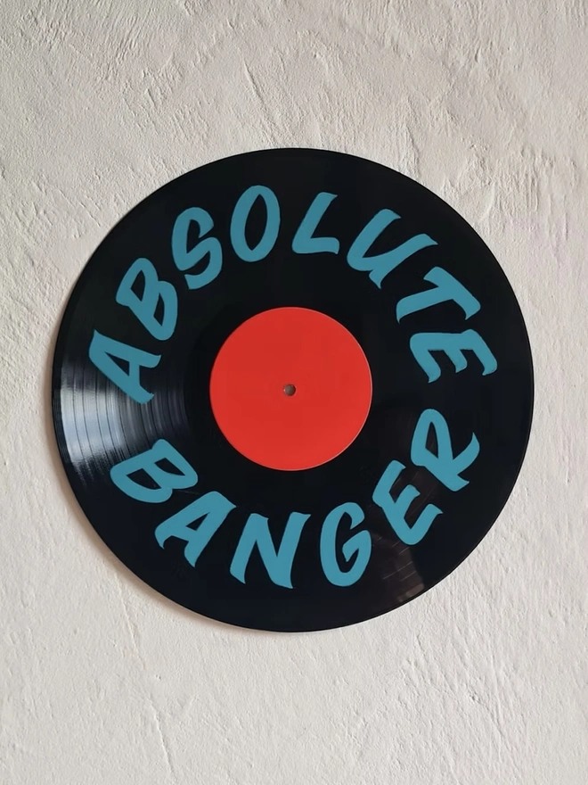 'Absolute Banger' 12" As Seen On TV Vinyl Artwork, a colourful vinyl sitting on a stone surface
