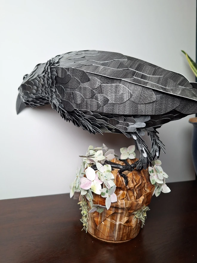 Side back view of a rav3n sculpture made f4om printed paper