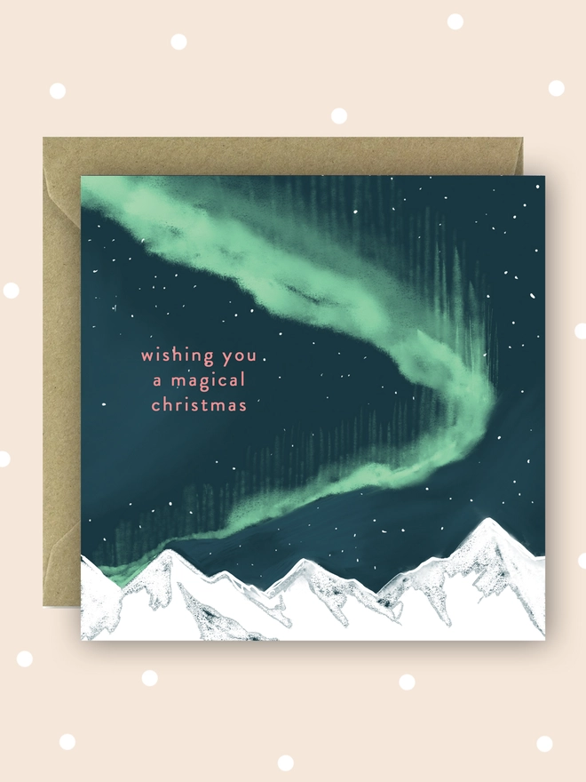 Wishing you a magical Christmas card, with a night sky and northern lights over some white mountains. Card measures 15x15cm