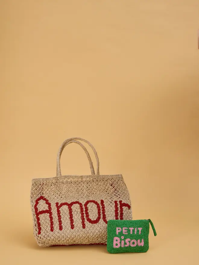 Jute bag with scarlet red writing reading 'amour.'