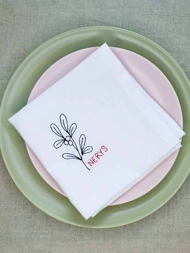 Mistletoe embroidered napkin with custom name in red block text, cotton Christmas napkin 