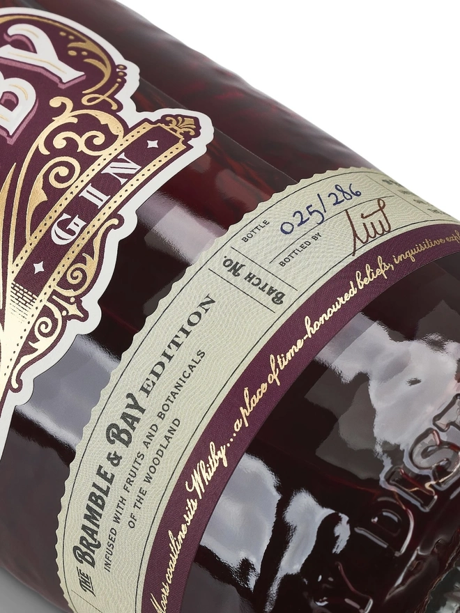Bramble & Bay Edition Gin, a bottle of gin sitting on a plain white surface. 