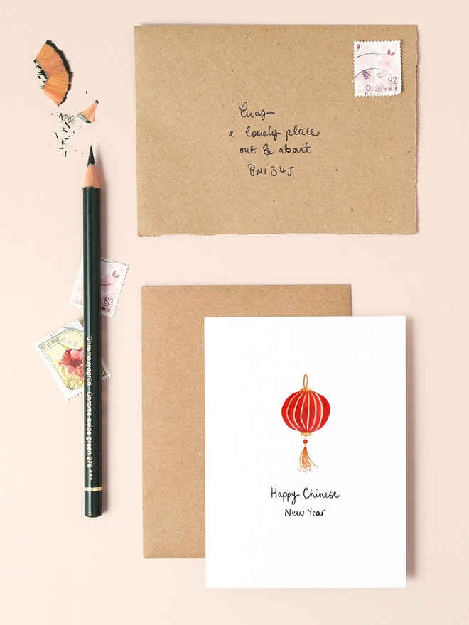 A vibrant illustration featuring a traditional Chinese New Year symbol, a stylised red lantern with gold accents. The intricate design captures the festive spirit of the celebration. The front of the card reads "Happy Chinese New Year" in elegant black lettering. This mini card is perfect for sending warm wishes and celebrating the start of a prosperous new year.