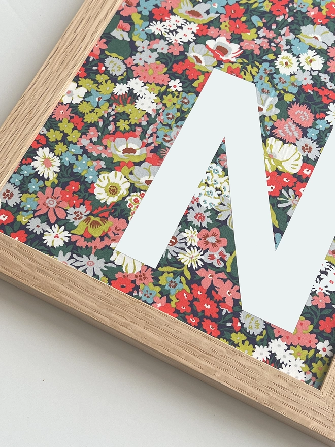 Personalised framed white initial on Liberty Thorpe Tana Mustard fabric - close up