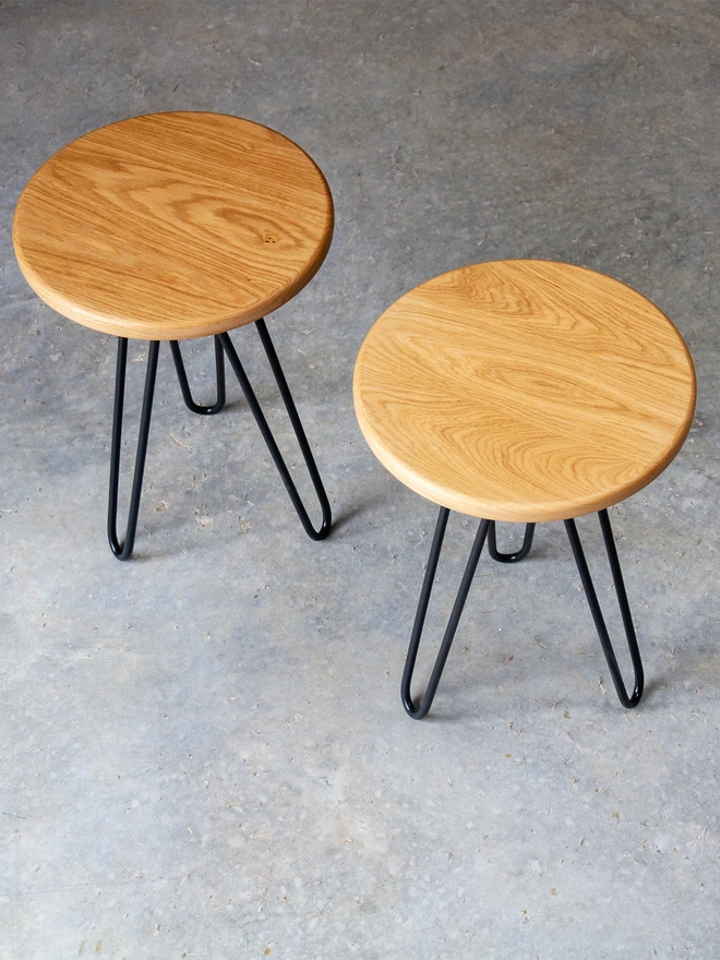 pair of hairpin leg side tables with oak tops and black hairpin legs
