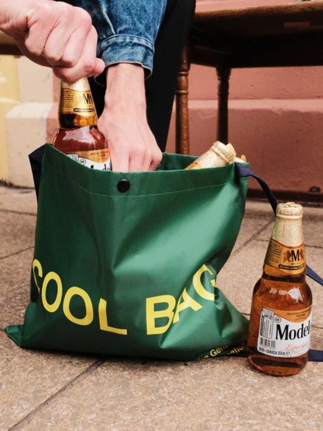 Cool bag thermal mussette bag, A green bag with 'cool bag' written on the front in yellow writing