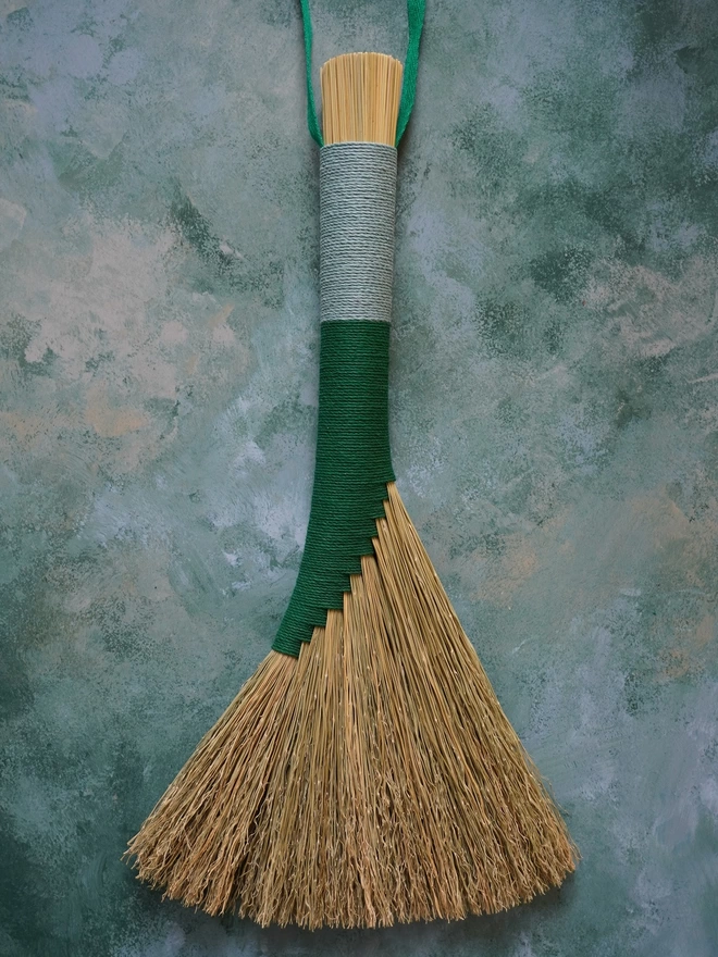 Broomcorn handbroom with green and light blue hemp cord binding
