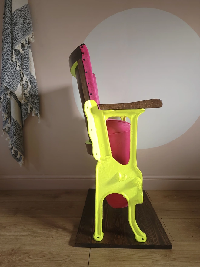 Side view of pink and yellow vintage cinema seat