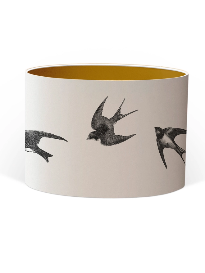 Handmade lampshade featuring graceful flying swallows swooping through a nature-inspired design, adding an elegant touch to any room.