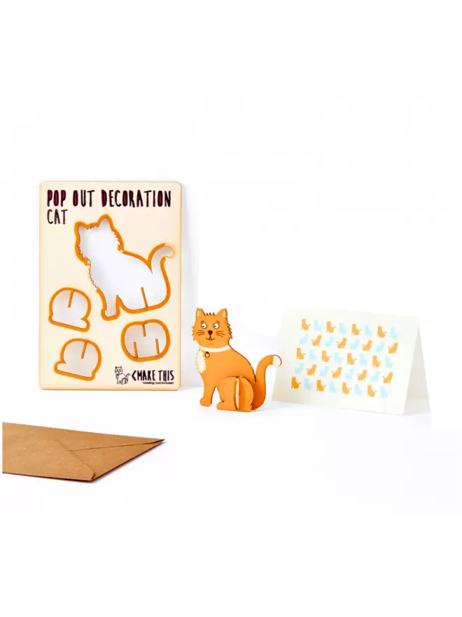 Ginger cat decoration and cat pattern greeting card and brown kraft envelope on a white background