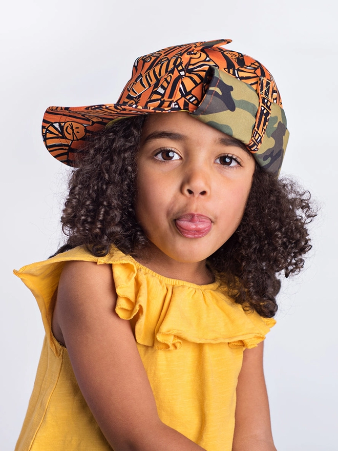 Girl wearing baseball sun hat in tiger print
