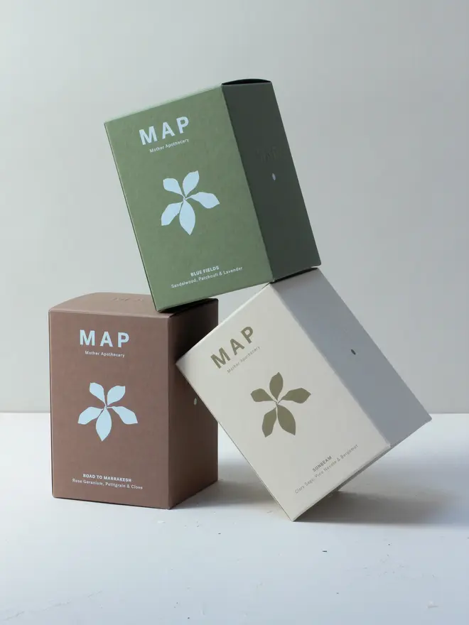 large aromatherapy soy wax candles (set of 3). candles pictured inside their boxes.