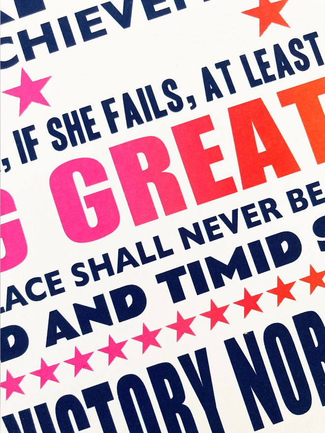Detail of a print with navy blue, pink and red text - Roosevelt quote that’s been altered from the man in the arena to "The credit belongs to the woman who is actually in the arena, whose face is marred by dust and sweat and blood; who strives valiantly ...who spends herself in a worthy cause; who at the best knows in the end the triumph of high achievement, and who at the worst, if she fails, at least fails while daring greatly, so that her place shall never be with those cold and timid souls who neither know victory nor defeat."