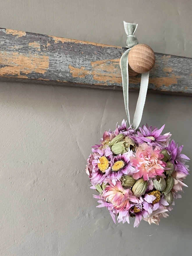 Pink and Green Dried Flower Bauble. A bauble made of dried seasonal flowers.