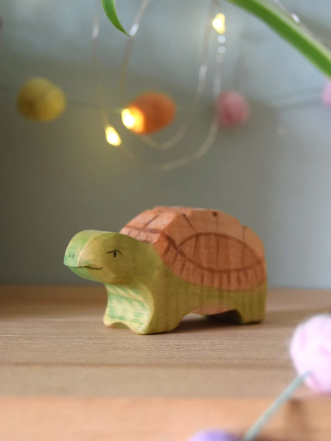 wooden toy tortoise on shelf 