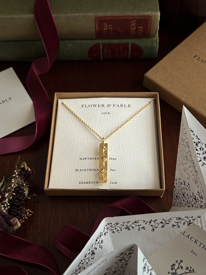 Sterling silver 24ct gold plated luck bar packaged in our box presentation on a dark background