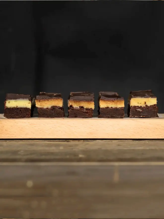 A tray of sliced billionaires brownies 